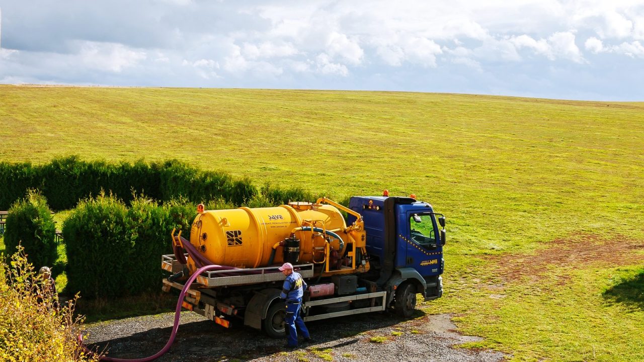 Sewage tank truck with pumping equipment, street setting