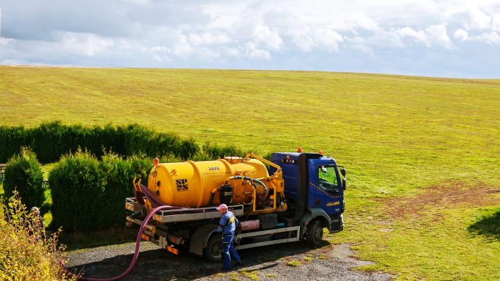 Sewage tank truck with pumping equipment, street setting