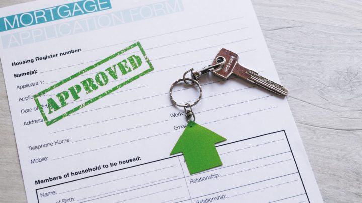 Filled-in property finance application form photographed flat