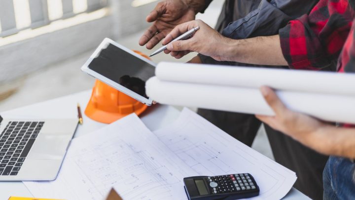 Contractor and architect reviewing a residential job site during renovation work