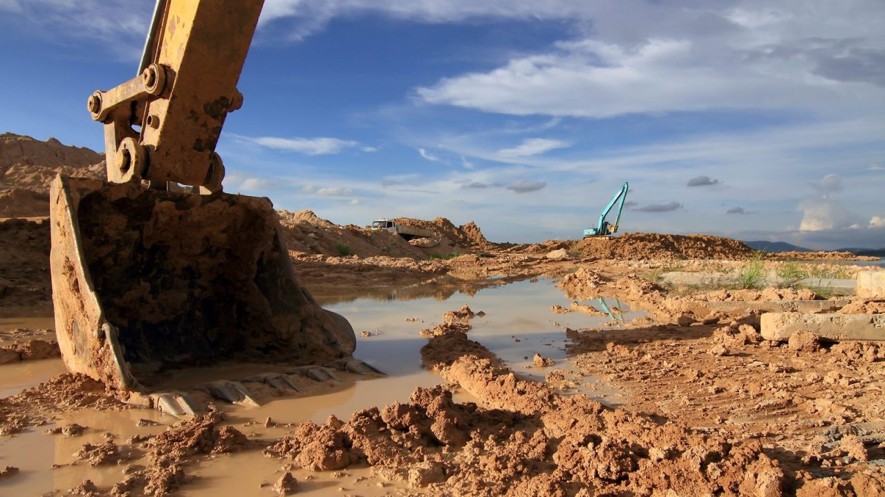 Backhoe loader moving earth on a construction site