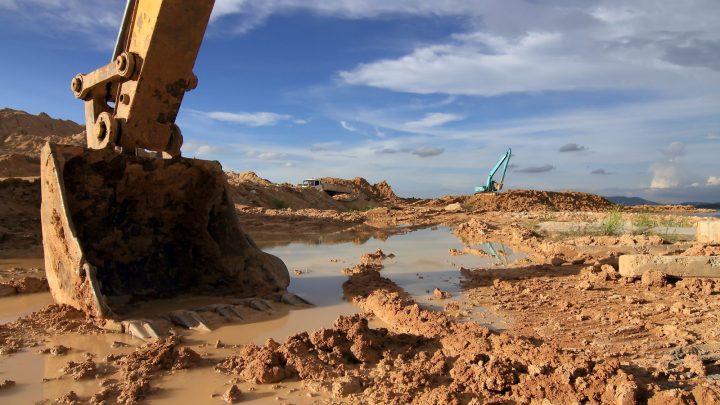 Backhoe loader moving earth on a construction site