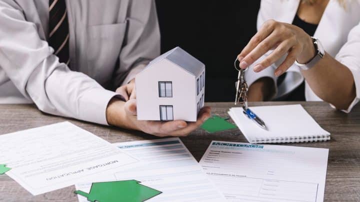 Agent handing house keys to a new property owner