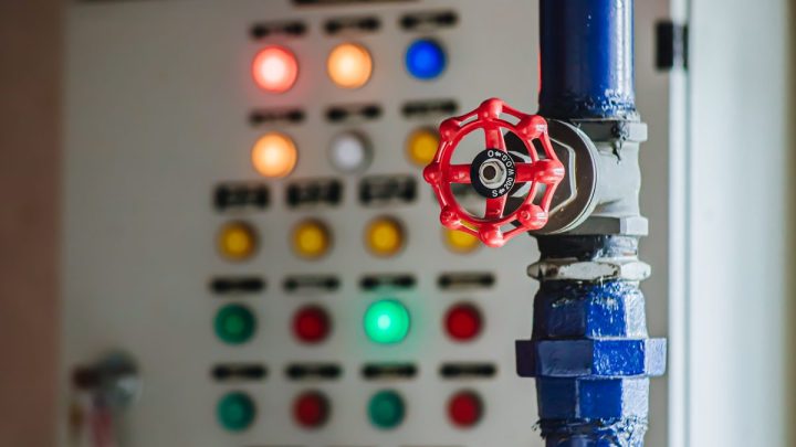 Valve in foreground with pump control panel and gauges behind